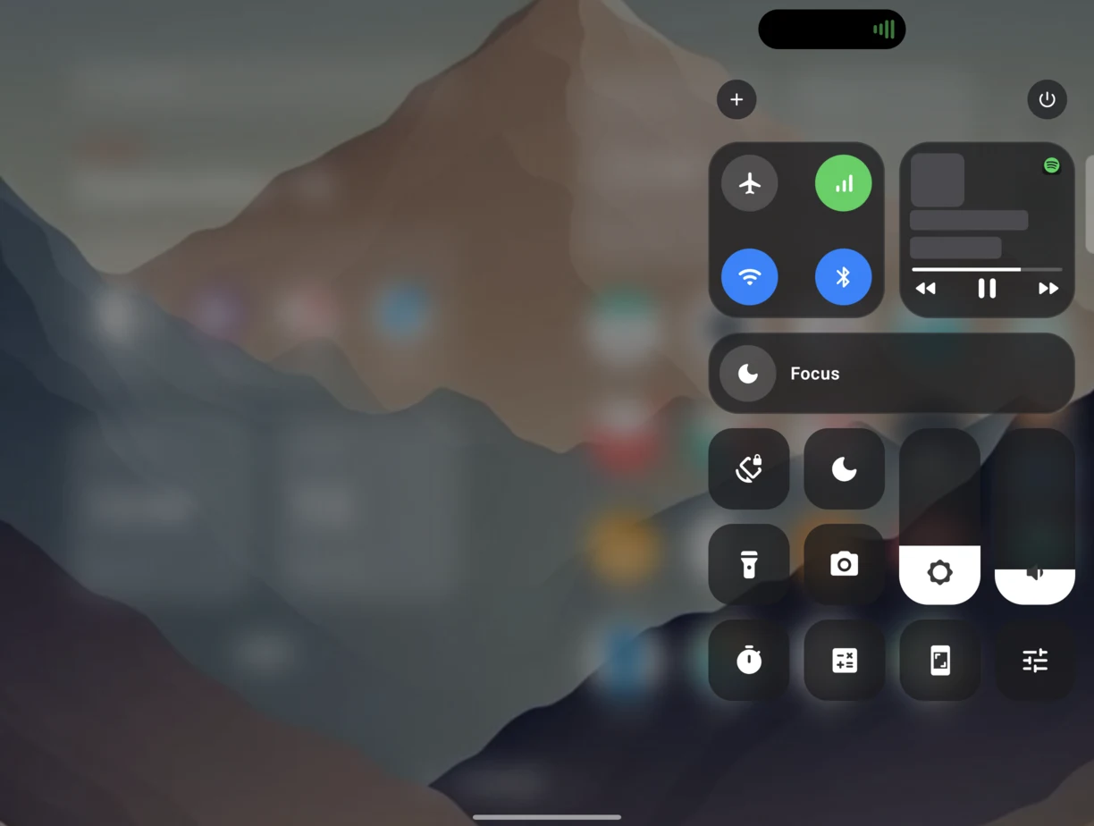 Control Center open on the unfolded screen, with tiles for connectivity, brightness and media